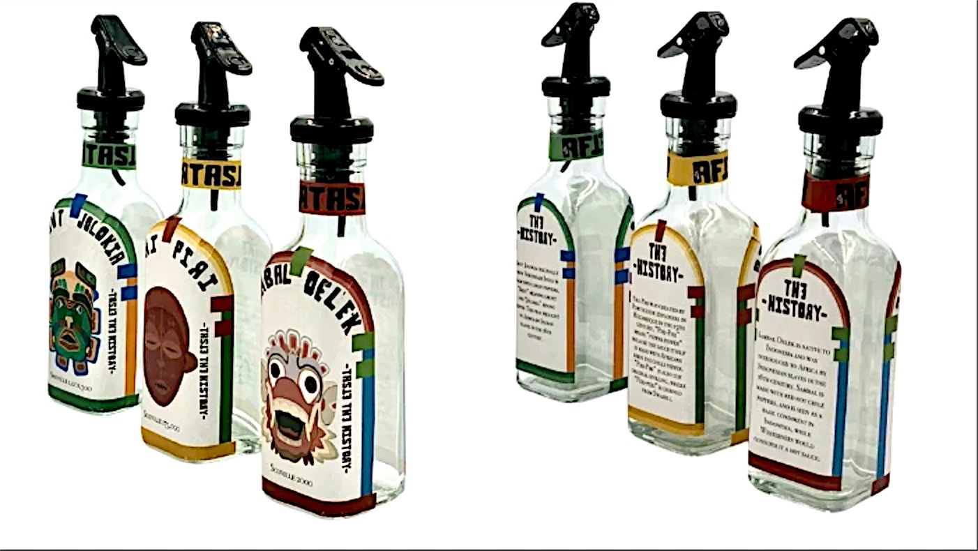 Front and back of the three glass hot sauce bottles with spray tops