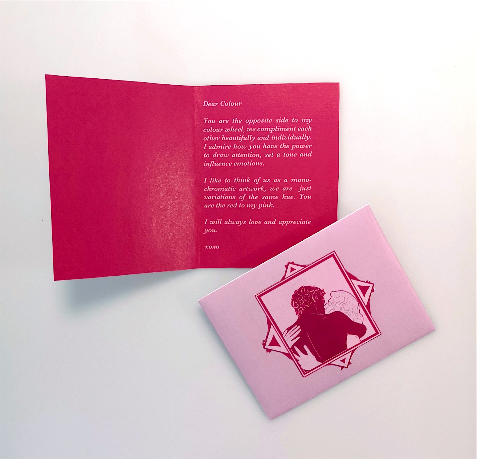 An open red letter beside a pink illustrated card